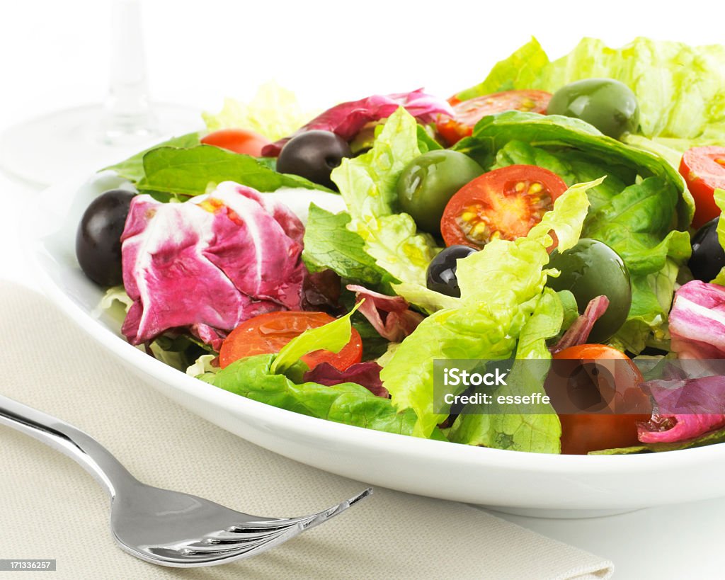 Salad with olives,tomato and chicory plate of fresh salad isolated on white  Appetizer Stock Photo