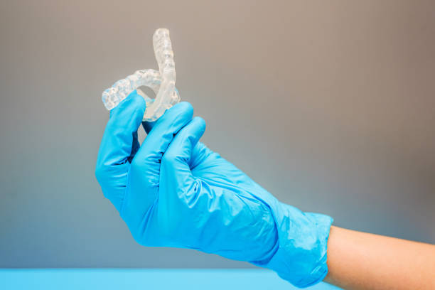 istock Dentist doctor hand holding a dental aligner, isolating on background. 1713363253