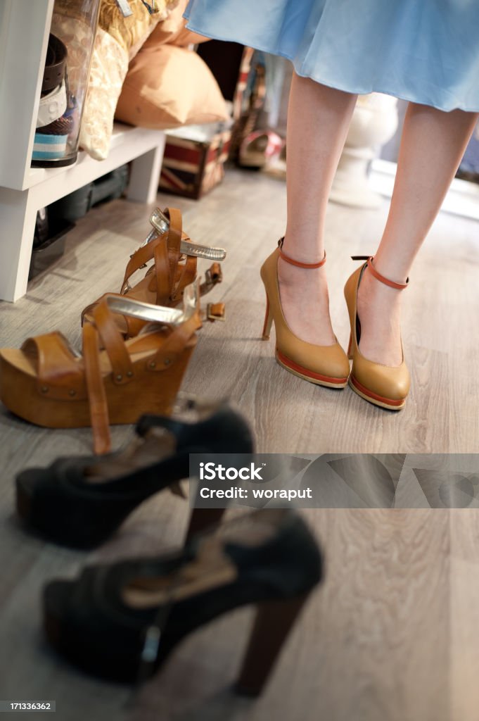 Woman in the shop to buy shoes Woman in the shop to buy shoes. Adult Stock Photo