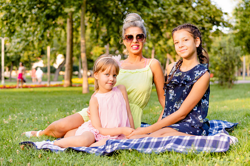 A mother with two daughters on a picnic