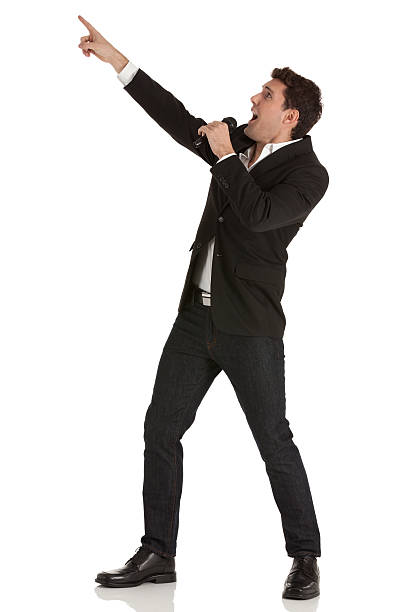 Businessman shouting into a microphone and pointing