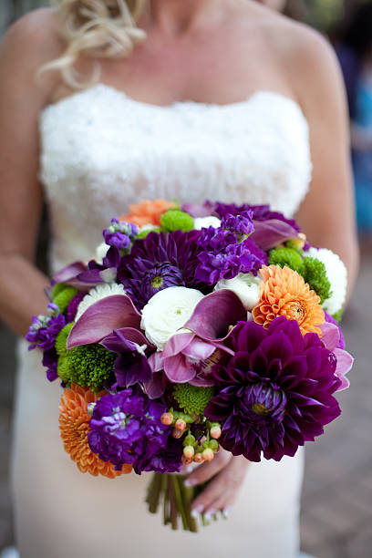 Bride holding colorful bouquet stock photo