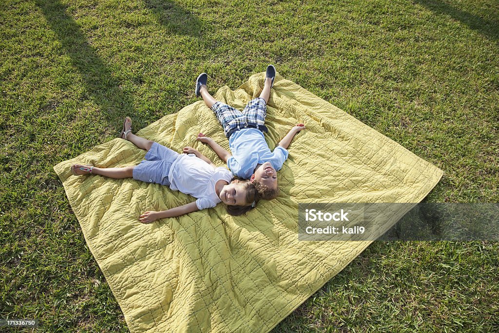 Dzieci bawiąc się leżeć na Koc piknikowy - Zbiór zdjęć royalty-free (Ogródek przydomowy)