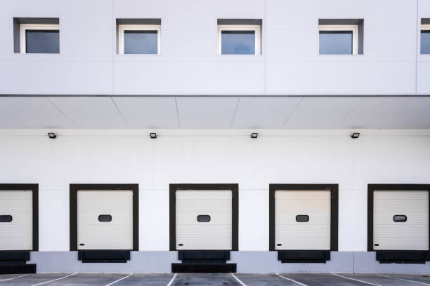 istock Closed doors of truck loading docks in a factory without activity. 1713369378