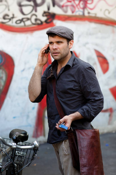 istock handsome mature man with flat cap at the phone 171337059