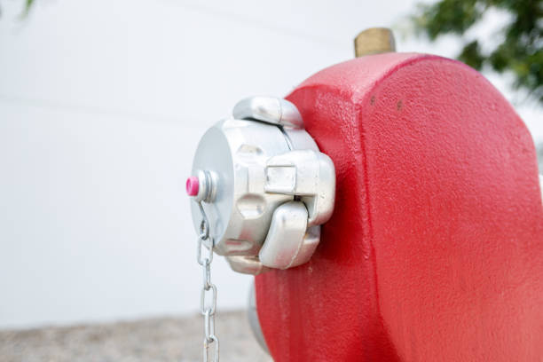 Red fire hydrant or fireplug connection for firefighters in public road for water supply