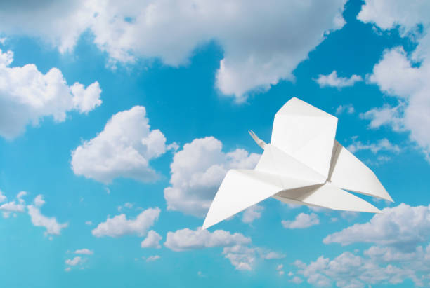 istock Flying white paper butterfly against blue sky 171337433