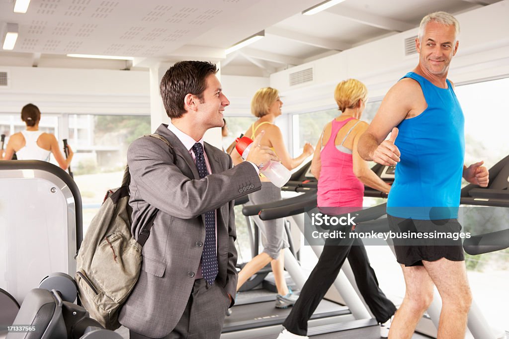 Businessman Arriving At Gym After Work Businessman Arriving At Gym After Work Talking Gym Stock Photo