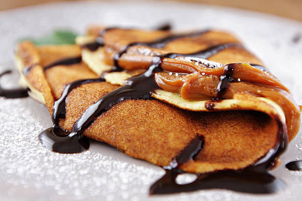 French crepes with caramel fudge on a spoon over