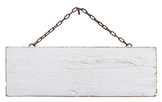 Old weathered white wood signboard, hanging by an old chain from a nail, composite image, isolated on white, clipping path included.