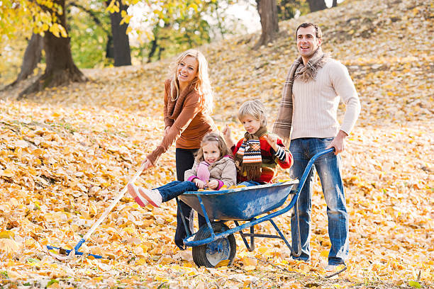 istock Young family raking leaves. 171338614