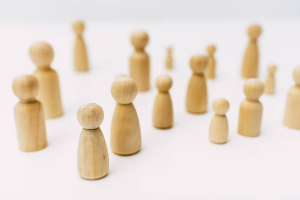 istock Group of confused grouped people, represented by wooden figures, isolated in studio on white background. 1713386492