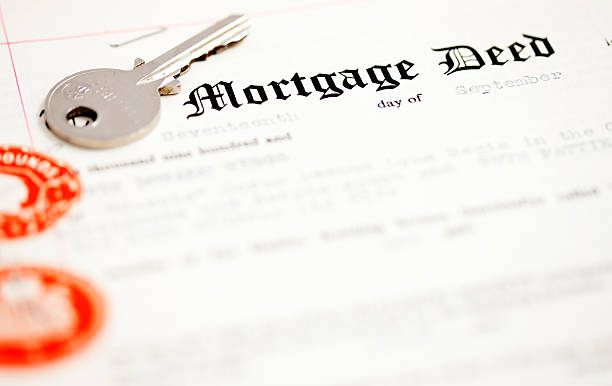 Mortgage deed document and key stock photo