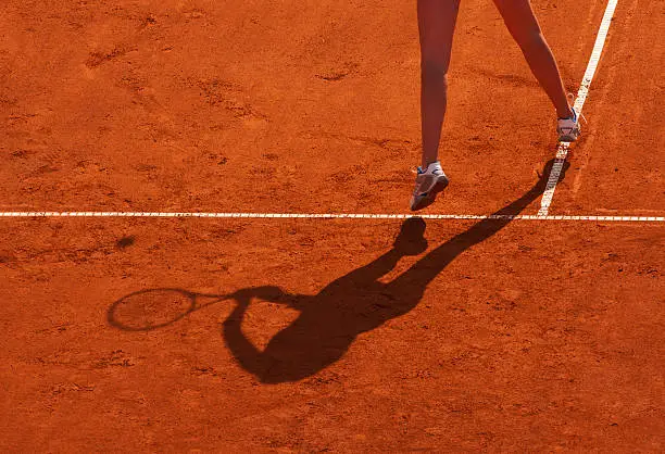 Clay tennis court with Tennis player legs. Roland Garros french open tournament