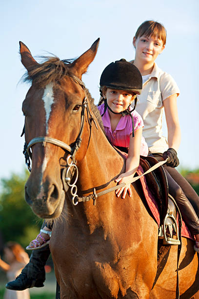 istock Child Riding Horse Outdoors. 171339146