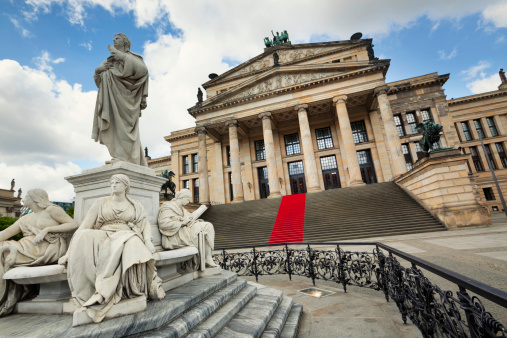 Konzerthaus Berlin on the Gendarmenmarkt square in the central Mitte district of Berlin. In the foreground stands a statue of german poet Friedrich Schiller made by the sculptor Reinhold Begas (1831-1911).