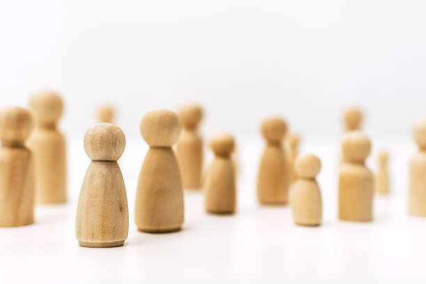 istock Group of confused grouped people, represented by wooden figures, isolated in studio on white background. 1713397197