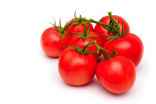Tomatoes isolated on white background. Fresh ripe red tomatoes bunched.