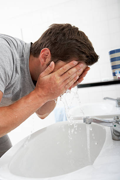 istock Man Washing Face In Bathroom Sink 171339964