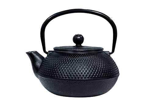 Ceramic teapot of black colour, tea drinking culture, oriental style, isolated on white background.