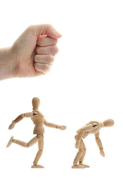 istock wooden mannequin kicking another in the butt 171340086