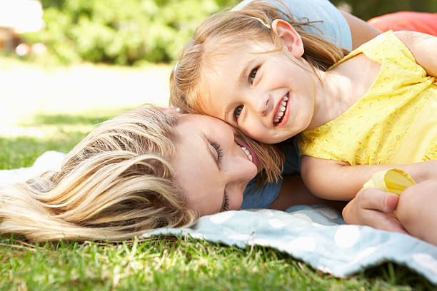 istock Mother And Daughter Relaxing In Garden 171340565