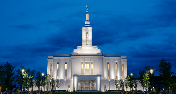 The Mormon Temple in Salt Lake City, reflected in the calm waters of a reflection pool.