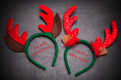 Santa reindeer horns with text, Merry Christmas and Happy new year, on blackboard