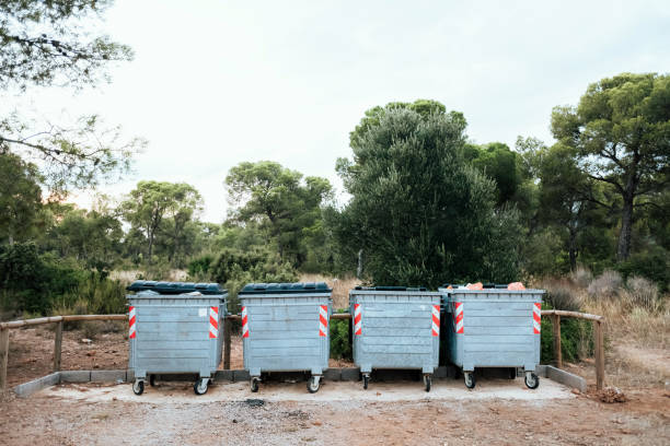 istock Metal garbage containers for urban waste in a field area. 1713413611