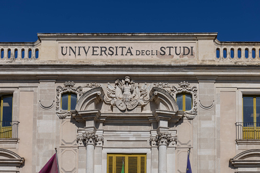 Catania, Sicily, Italy - April 26, 2023: Decorative facade of Palazzo San Giuliano located in University square (Piazza dell'Universita). University of Catania is located there now