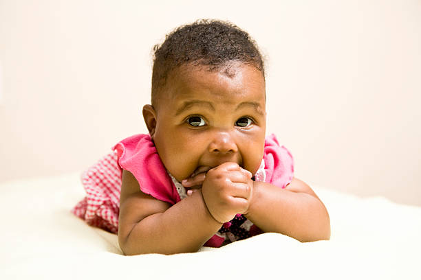 Baby girl looking at camera stock photo