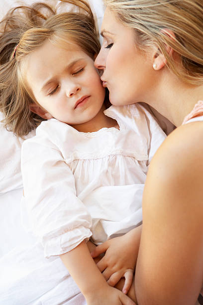 istock Mother And Daughter Sleeping In Bed 171341575