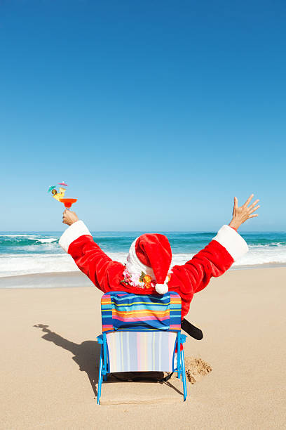 istock Happy Christmas Santa with Drinks Vacationing on Tropical Beach Vt 171341657