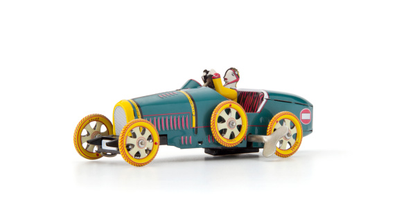 An old wind up tin toy race car.