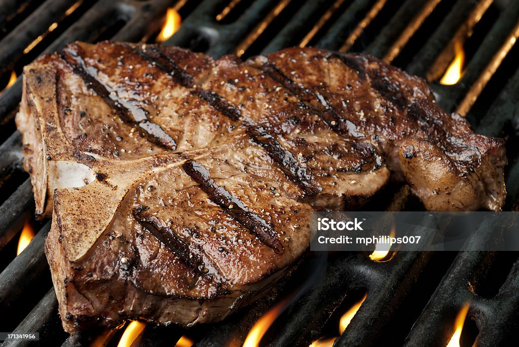 Grilled T-Bone T-Bone Steak on a hot grill.  Please see my portfolio for other food related images. Char-Grilled Stock Photo