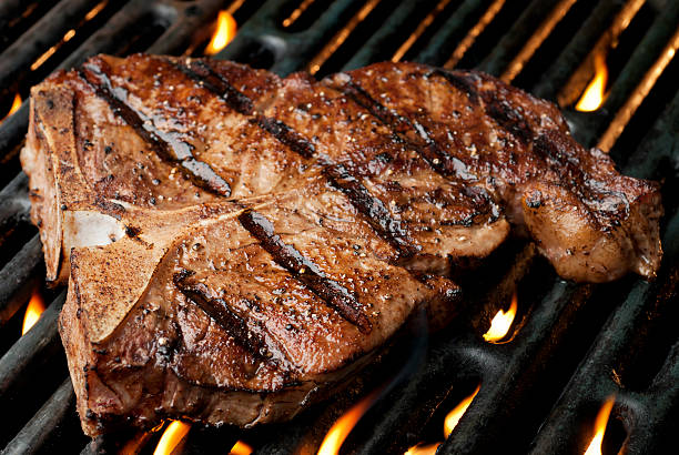 Grilled T-Bone T-Bone Steak on a hot grill.  Please see my portfolio for other food related images. porterhouse steak stock pictures, royalty-free photos & images