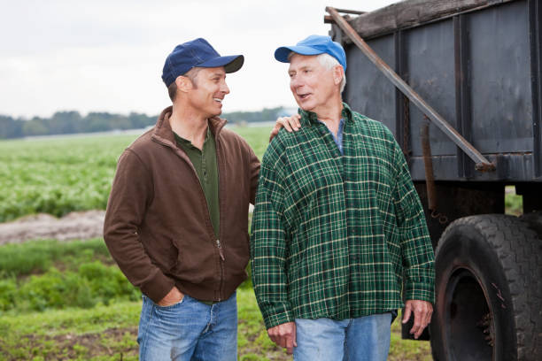 istock Two men working on a farm, talking by a truck 171342019