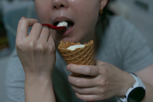 Mouth eat and hold icream ,close up