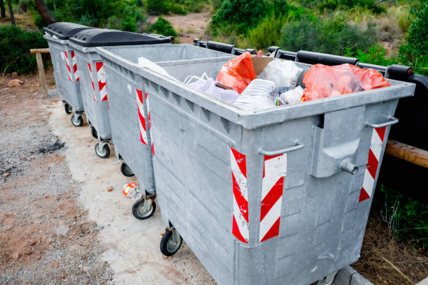 istock Metal garbage containers for urban waste in a field area. 1713421380