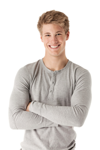 Attractive happy man standing with his arms crossed