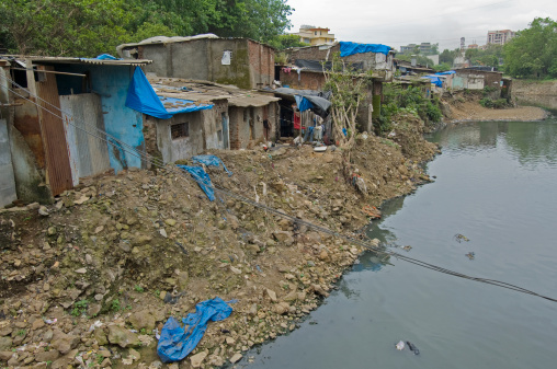 shanty town on the shore of a sewage canal in sakinaka district. mumbai. maharashtra. india. asia.