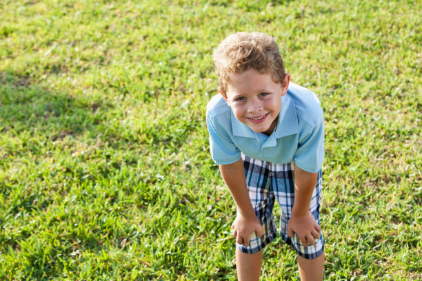 Close-up portrait of cheerful redhead boy at the backyard