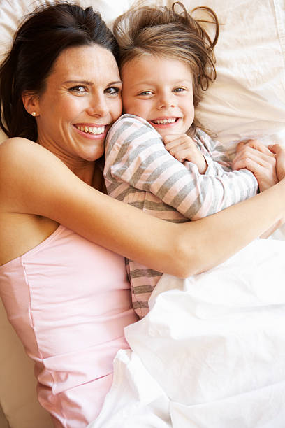 istock Mother And Daughter Relaxing In Bed 171342592