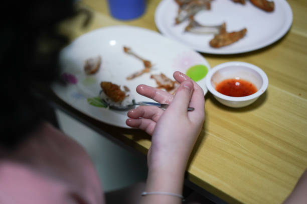 hand holding food and snack while eating on table