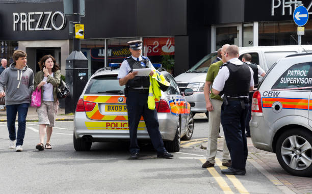 Crime scene - police investigating a robbery "Beckenham, England - August 2, 2012: Curious passersby watching police officers who were investigating a violent robbery in the High Street in Beckenham, Kent. Beckenham is a suburb of south east London. The incident occurred adjacent to a Safer Bromley sign." borough of bromley photos stock pictures, royalty-free photos & images