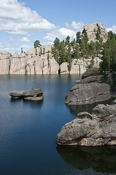 Rocks protrude into the serene Sylvan Lake in the Black Hills of South Dakota.