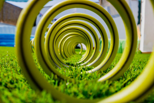 Green hose on the grass and compressed coiled.