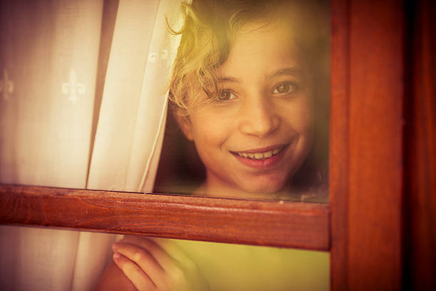 istock Little girl looking throught window 171343167