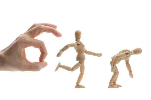 istock wooden mannequin kicking another in the butt 171343458