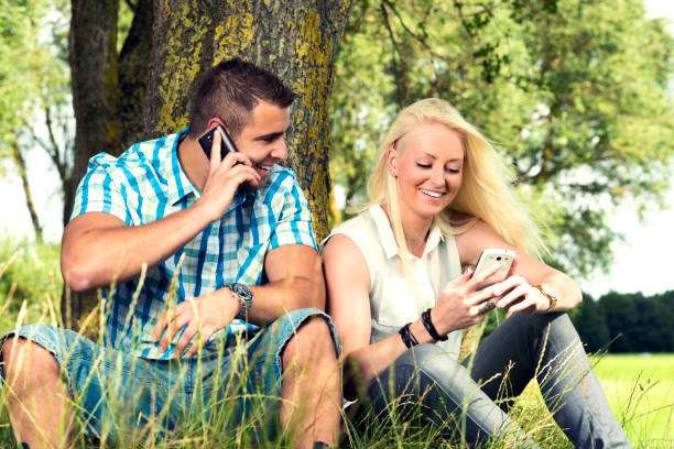 istock Young couple plays with smart phone outside 171343596